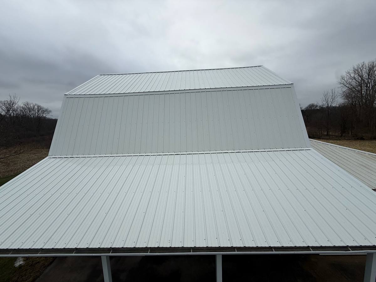 White metal barn roof after soft washing by Elite Softwash, uniform streak free finish